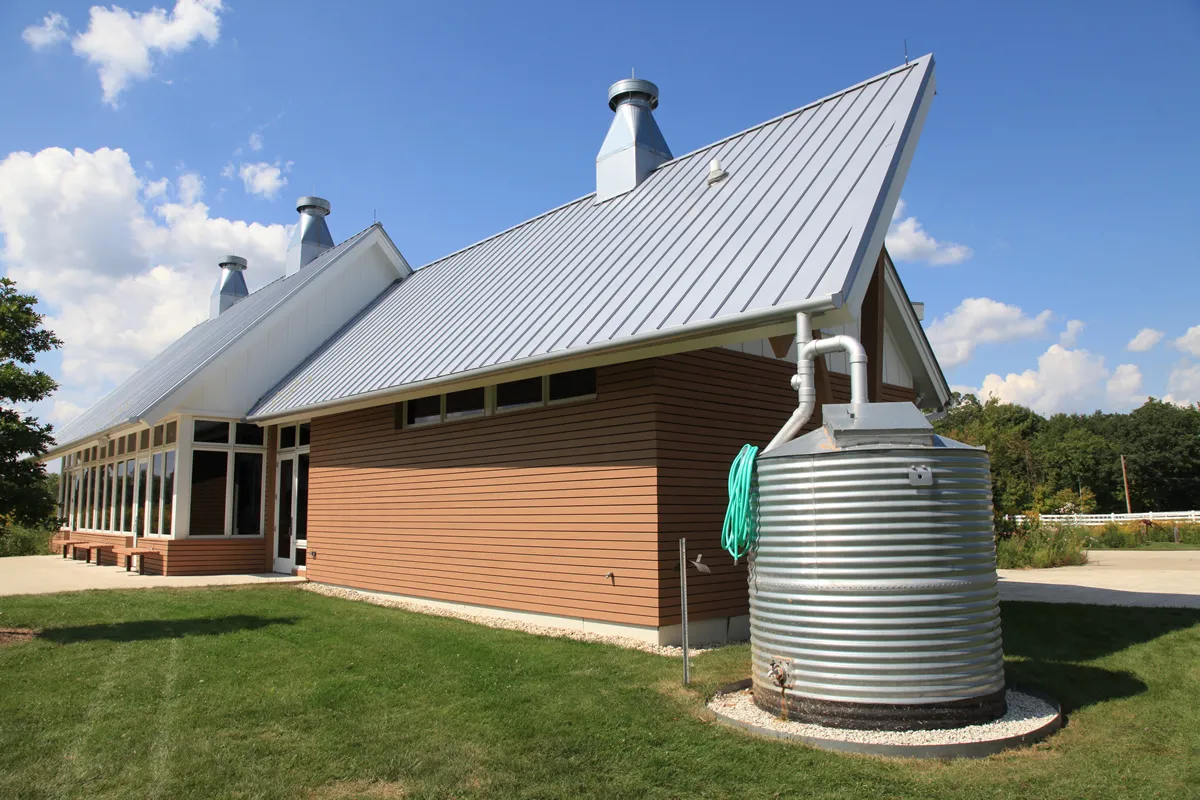 Modern silver cistern collects rainwater, using green architecture